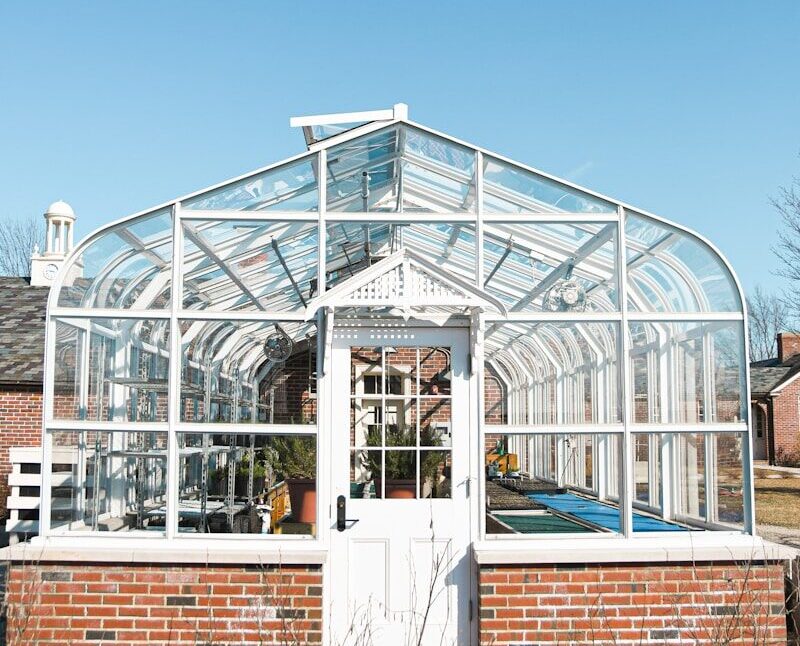 white metal framed glass building under blue sky during daytime